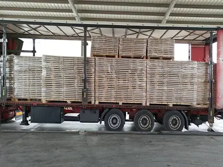 Truck being loaded with lumber packs